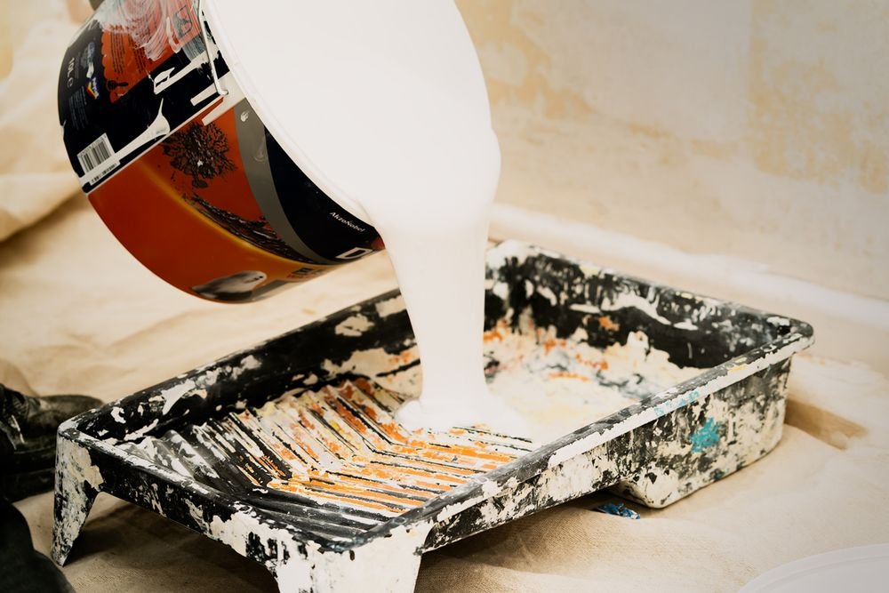 White coating pigment being poured during industrial paint production